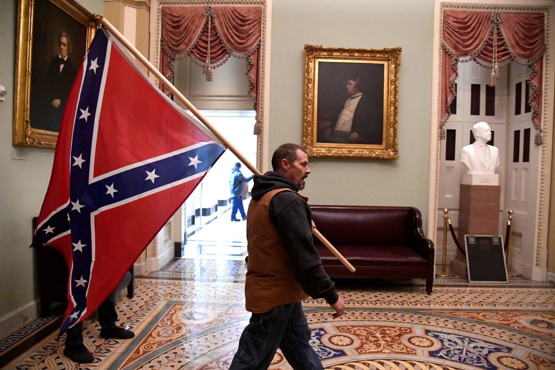 A Trump supporter carries a Confederate flag on the second floor of the US Capitol on Wednesday. 