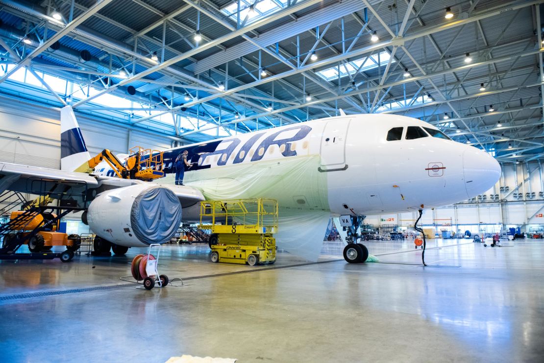 In Helsinki, Finnair employees painted over the airline's livery on an A319 bound for the scrapyard.