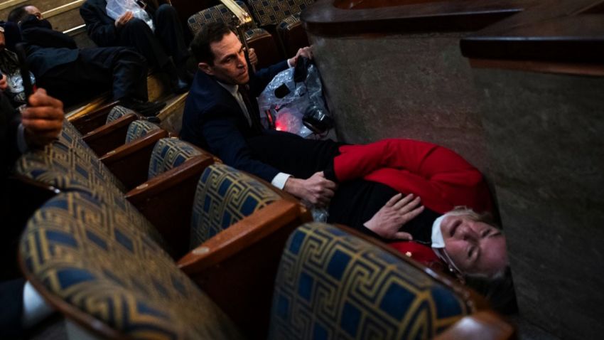 UNITED STATES - JANUARY 6: Rep. Jason Crow, D-Colo.,  comforts Rep. Susan Wild, D-Pa., while taking cover as protesters disrupt the joint session of Congress to certify the Electoral College vote on Wednesday, January 6, 2021. (Photo By Tom Williams/CQ-Roll Call, Inc via Getty Images)