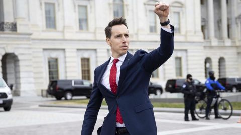 Sen. Josh Hawley gestures toward a crowd of supporters of President Donald Trump gathered outside the US Capitol to protest the certification of President-elect Joe Biden's electoral college victory Jan. 6, 2021. Some demonstrators later breached security and stormed the Capitol. 
