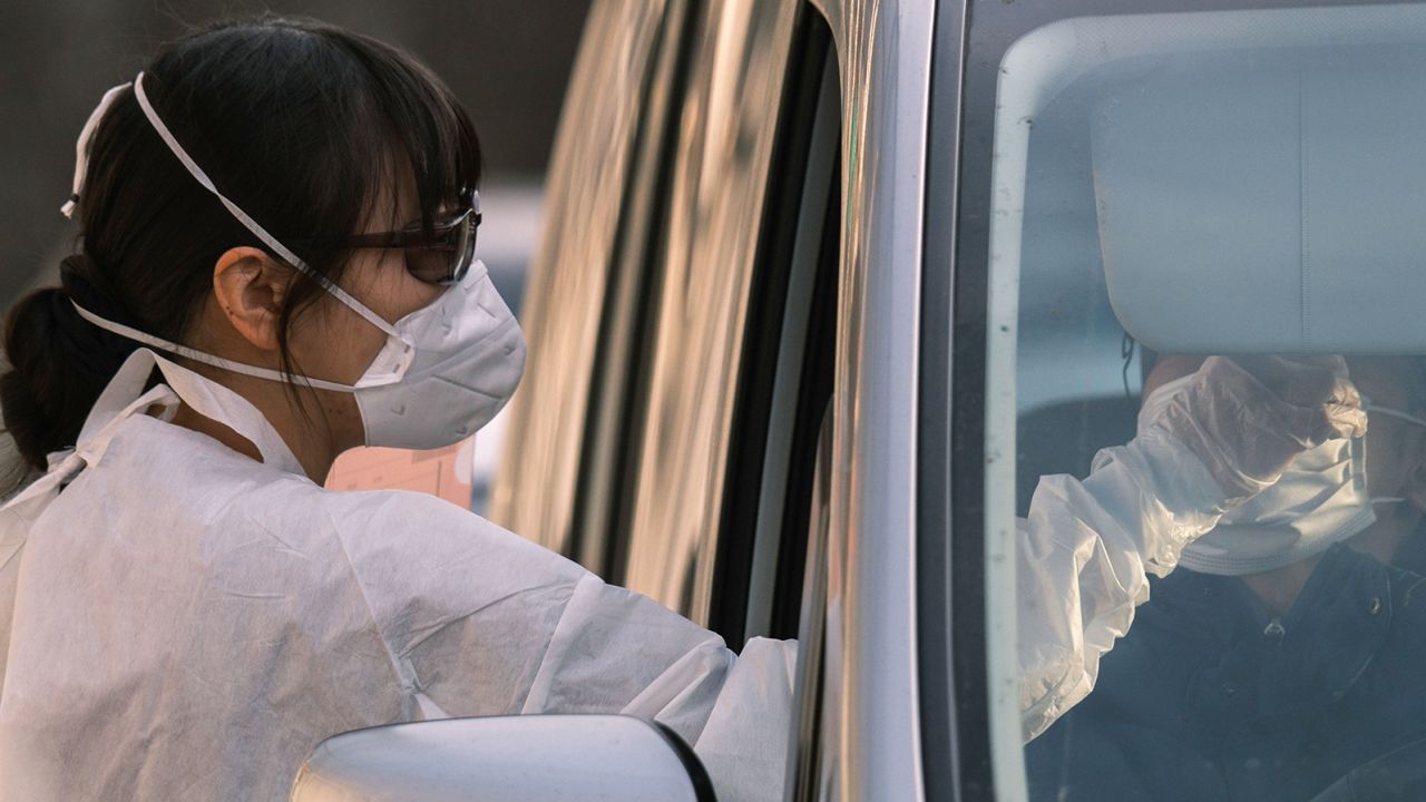A nurse collects a nasal swab sample at a Covid-19 coronavirus PCR testing centre at Fujimino Emergency Hospital in Miyoshi-machi, Japan. 