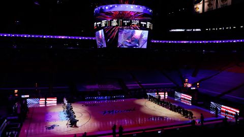 The Boston Celtics and Miami Heat kneel before an NBA game Wednesday.