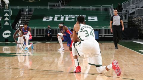 Players from the Bucks and Pistons kneel shortly after the start of an NBA game Wednesday.