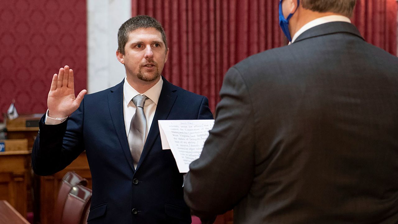 West Virginia House of Delegates member Derrick Evans, left, is given the oath of office Dec. 14, 2020, in the House chamber at the state Capitol in Charleston, W.Va. Evans recorded video of himself and fellow supporters of President Donald Trump storming the U.S. Capitol in Washington, D.C., on Wednesday, Jan. 6, 2021 prompting calls for his resignation and thousands of signatures on an online petition advocating his removal. (Perry Bennett/West Virginia Legislature via AP)