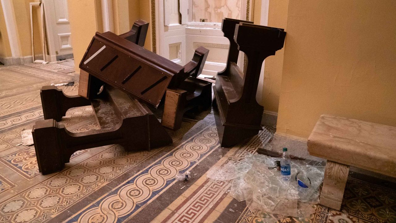 Broken benches and shattered glass littered the floor in one hallway of the US Capitol on Wednesday. 