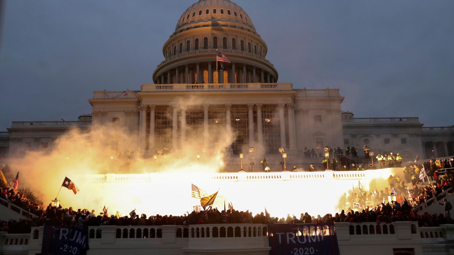 An explosion caused by a police munition is seen while supporters of President Donald Trump gather in front of the US Capitol in Washington on Wednesday, January 6.