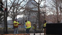 Workers erect a fence around the U.S. Capitol Building the day after a pro-Trump mob broke into the building on January 07, 2021 in Washington, DC. Congress finished tallying the Electoral College votes and Joe Biden was certified as the winner of the 2020 presidential election. 