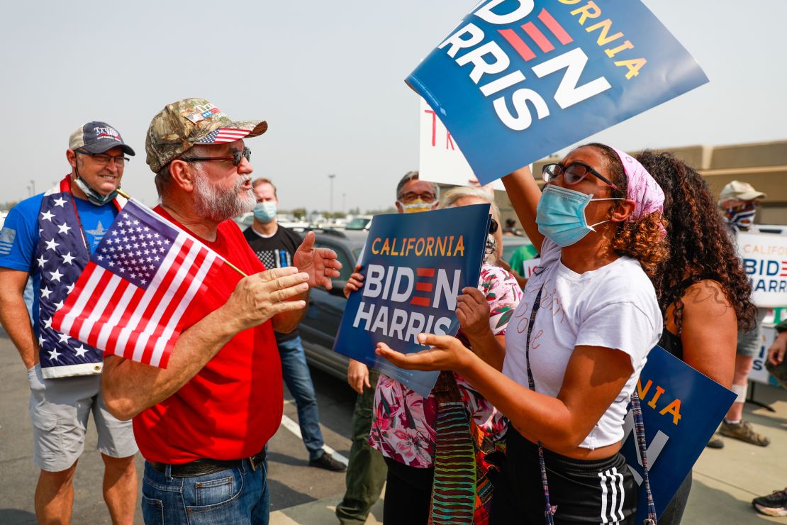 A Donald Trump supporter argues with a Joe Biden supporter outside Sacramento McClellan Airport in California, September 14, 2020.