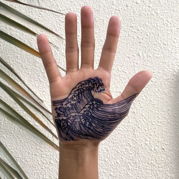 Jagua is a blackish-blue dye made from the juices of the Amazonian jagua fruit. Khamissa uses this natural dye for some of her designs, which "look more like a tattoo" than traditional orange-brown henna dye. 