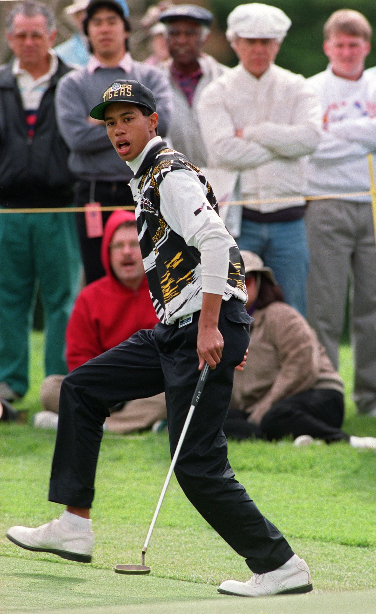 High school student Woods, 17, reacts after making a birdie putt on the 15th hole of the Los Angeles Open.