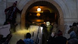 A demonstrator sprays a chemical irritant at law enforcement officers at the U.S. Capitol building during a protest in Washington, D.C., U.S., on Wednesday, Jan. 6, 2021. The U.S. Capitol was placed under lockdown and Vice President Mike Pence left the floor of Congress as hundreds of Demonstrators swarmed past barricades surrounding the building where lawmakers were debating Joe Biden's victory in the Electoral College. Photographer: Eric Lee/Bloomberg via Getty Images