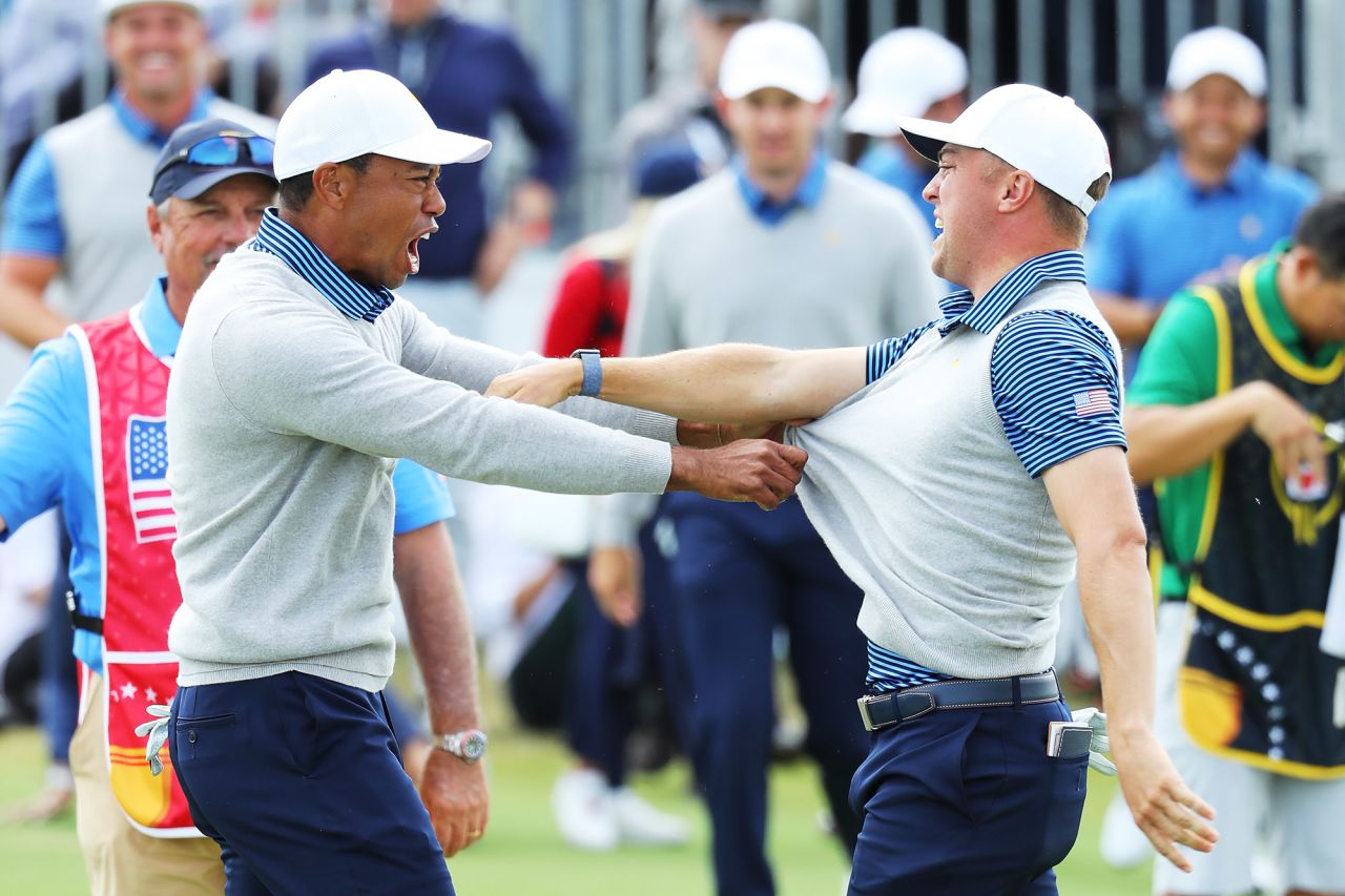 Justin Thomas and playing captain Woods celebrate after winning their foursome in the 2019 Presidents Cup. 