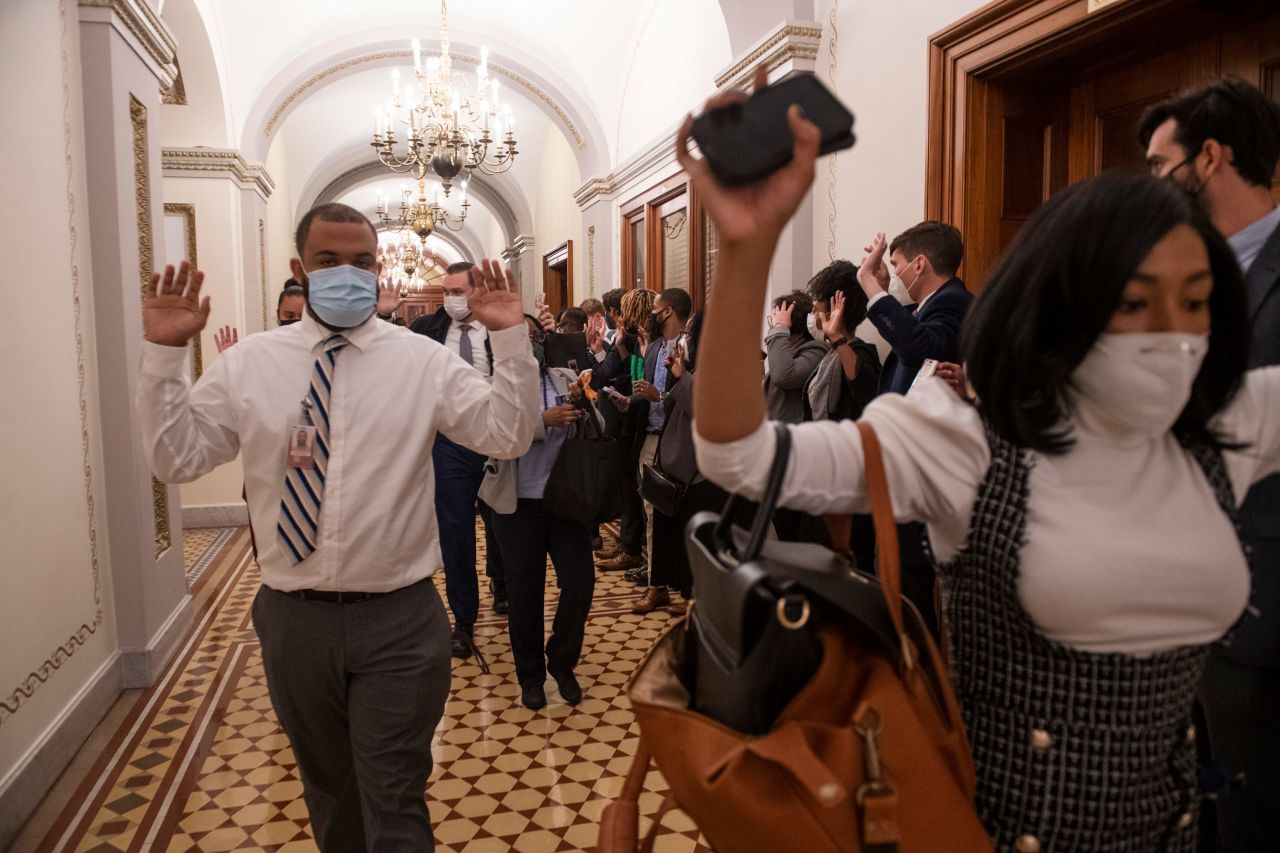 Congressional staffers evacuate the Capitol.
