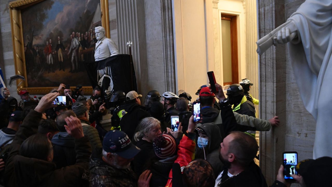 TOPSHOT - Supporters of US President Donald Trump protest in the US Capitol's Rotunda on January 6, 2021, in Washington, DC. - Demonstrators breeched security and entered the Capitol as Congress debated the a 2020 presidential election Electoral Vote Certification. (Photo by Saul LOEB / AFP) (Photo by SAUL LOEB/AFP via Getty Images)
