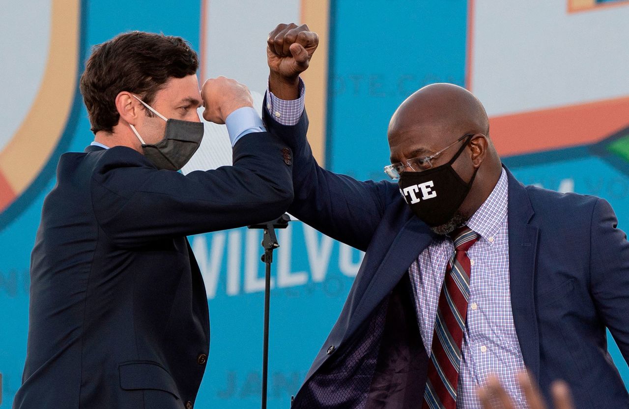 US Senate candidates Jon Ossoff, left, and the Rev. Raphael Warnock bump elbows during a rally in Atlanta on Monday, January 4. The two candidates <a href="https://www.cnn.com/2021/01/06/politics/ossoff-perdue-georgia-election-news/index.html" target="_blank">won their runoff elections in Georgia</a>, CNN projected Wednesday, giving the Democratic Party control of Congress and the White House for the first time in a decade