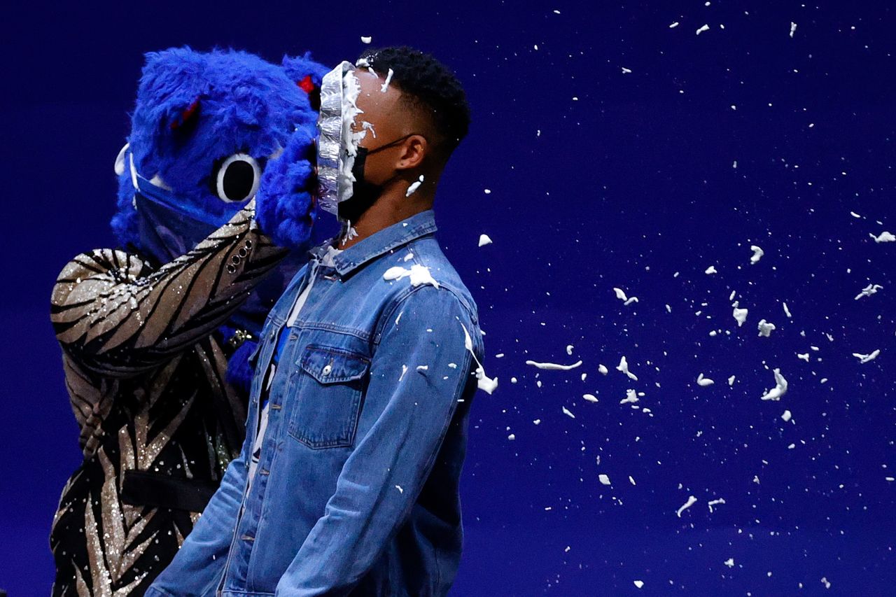 Philadelphia 76ers in-arena host Christian Crosby is hit in the face with a pie by the NBA team's mascot, Franklin, during a game on Monday, January 4.