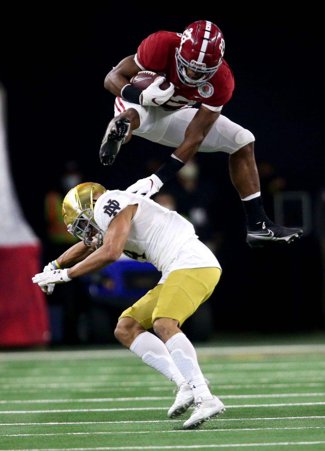 Alabama running back Najee Harris <a href="https://www.cnn.com/2021/01/01/us/najee-harris-megan-rapinoe-hurdle-spt-trnd/index.html" target="_blank">hurdles Notre Dame cornerback Nick McCloud </a>during a College Football Playoff semifinal on Friday, January 1. Alabama won 31-14 to book a spot in the title game.