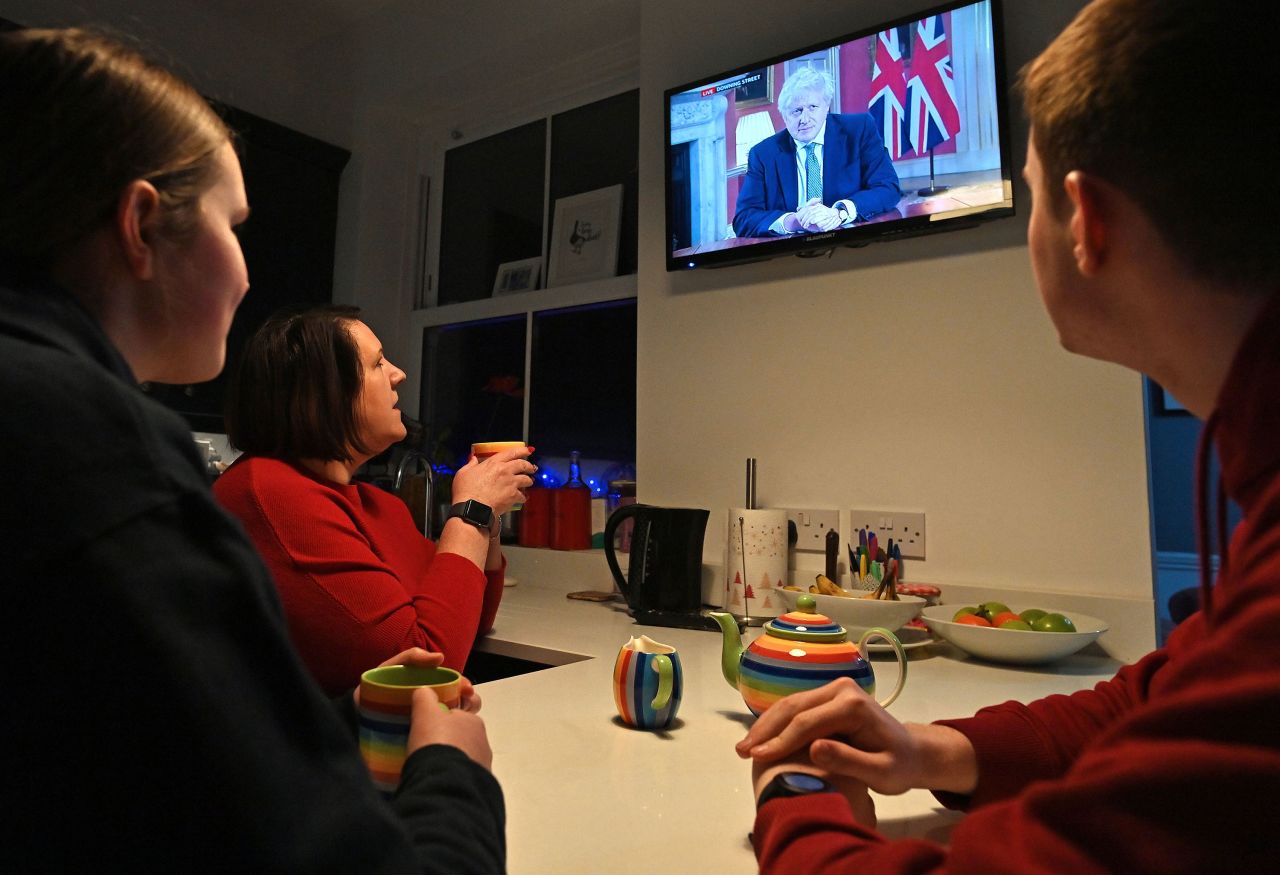 A family gathers around the television in Liverpool, England, as British Prime Minister Boris Johnson addresses the nation on Monday, January 4. <a href="https://www.cnn.com/2021/01/04/uk/uk-lockdown-covid-19-boris-johnson-intl/index.html" target="_blank">Johnson reimposed a lockdown in England</a> as a more transmissible variant of Covid-19 fuels a surge in infections and hospitalizations in the country.