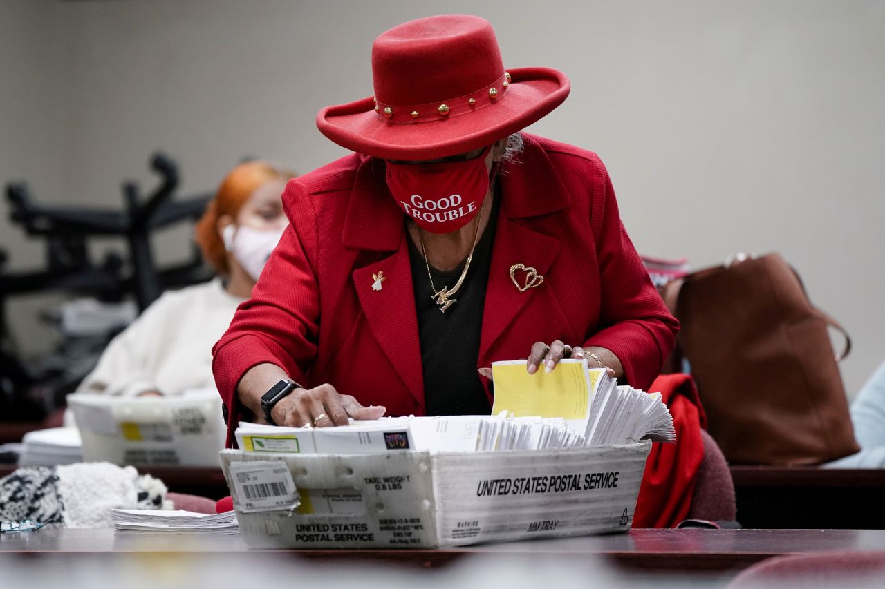 A DeKalb County election worker wearing a "Good Trouble" face mask sorts empty absentee-ballot envelopes in Decatur, Georgia, on Wednesday, January 6. It was a day after the state's runoffs for the US Senate.