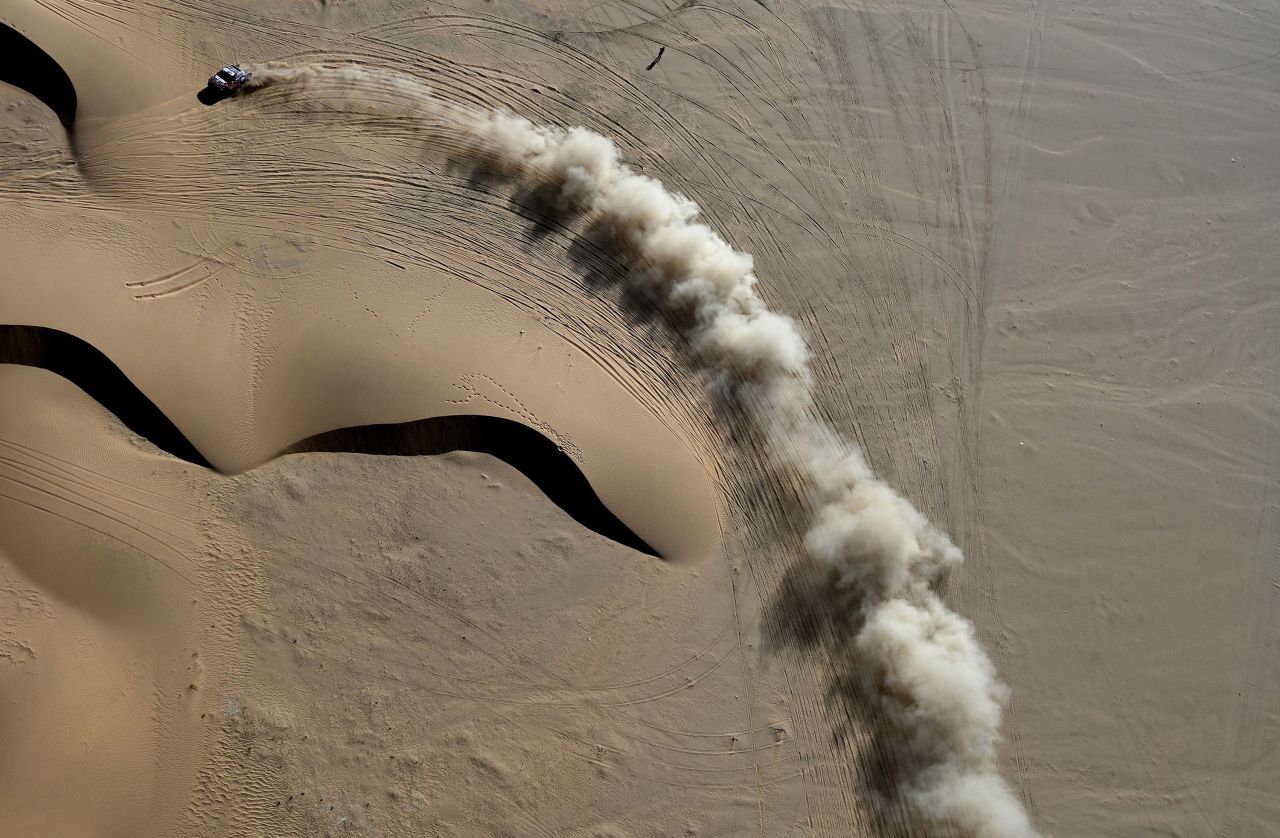 A vehicle kicks up sand while competing in stage 2 of the Dakar Rally on Monday, January 4. This year's event is taking place in Saudi Arabia.