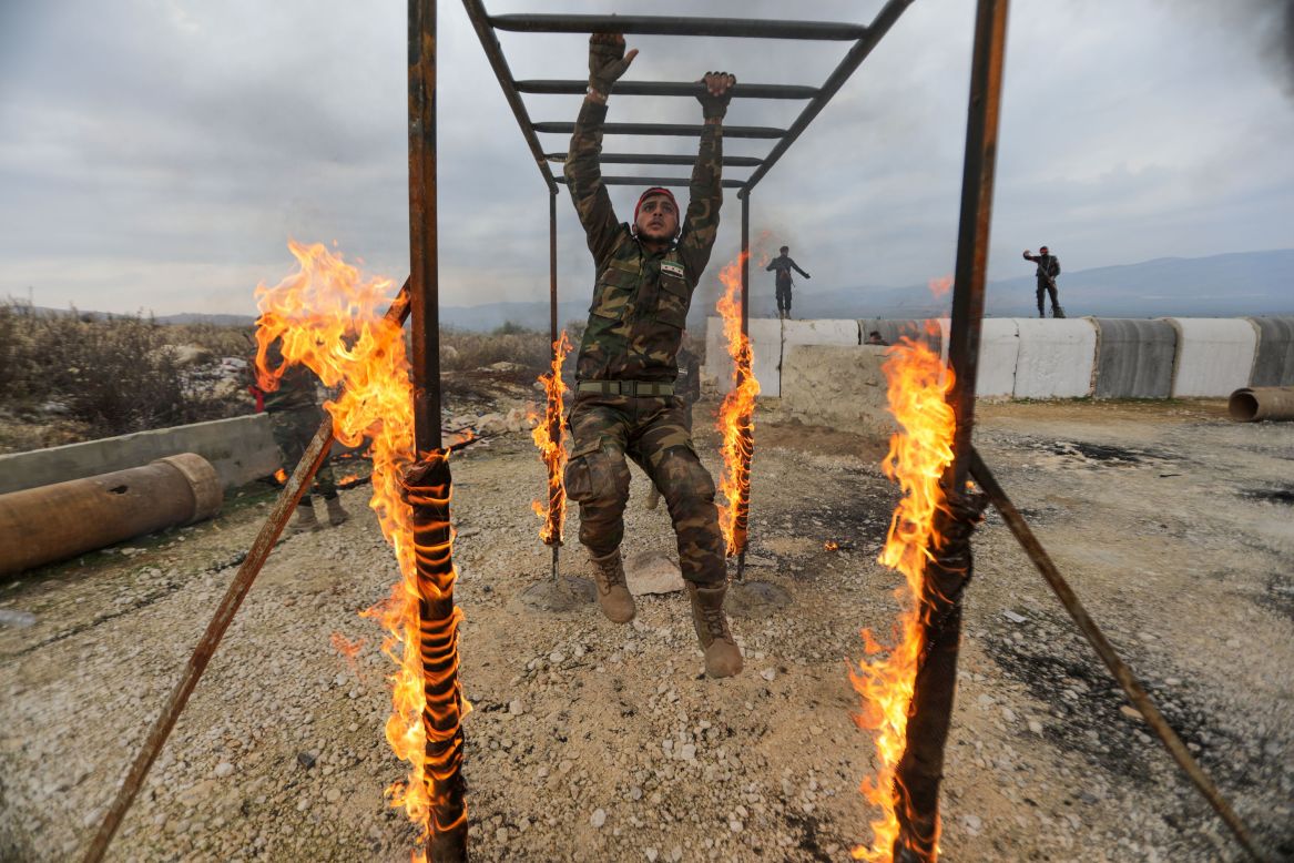 A Syrian fighter takes part in military training at a base near the village of Al-Maabatli on Saturday, January 2.