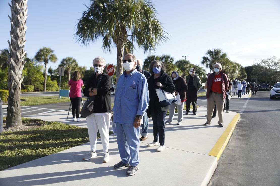 Seniors wait in line outside a library in Fort Myers last week, hoping to get one of 800 doses of coronavirus vaccine available at the site.