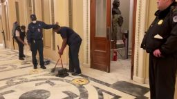 The same House chamber doors where the armed standoff took place hours ago is being cleaned for members to return for the joint session.