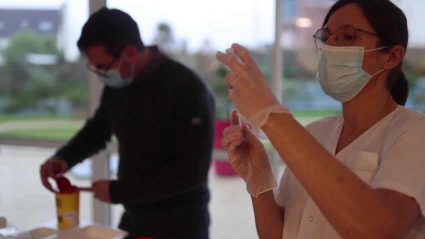 A European health worker prepares a shot of the coronavirus vaccine.