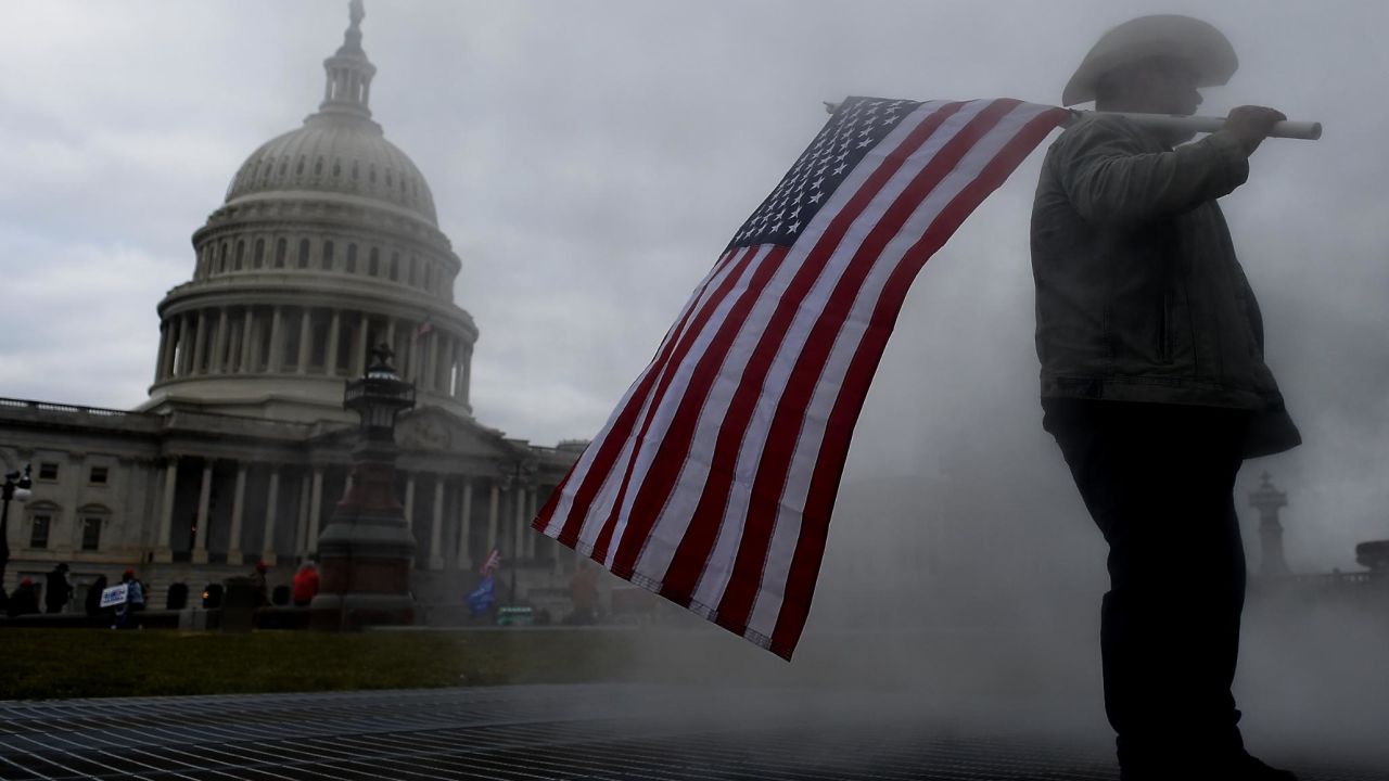 TOPSHOT - Supporters of US President Donald Trump hold a rally outside the US Capitol as they protest the upcoming electoral college certification of Joe Biden as President in Washington, DC on January 6, 2021. - Joe Biden's Democratic Party took a giant step Wednesday towards seizing control of the US Senate as they won the first of two Georgia run-offs, hours before Congress was set to certify the president-elect's victory over Donald Trump. (Photo by Olivier DOULIERY / AFP) (Photo by OLIVIER DOULIERY/AFP via Getty Images)