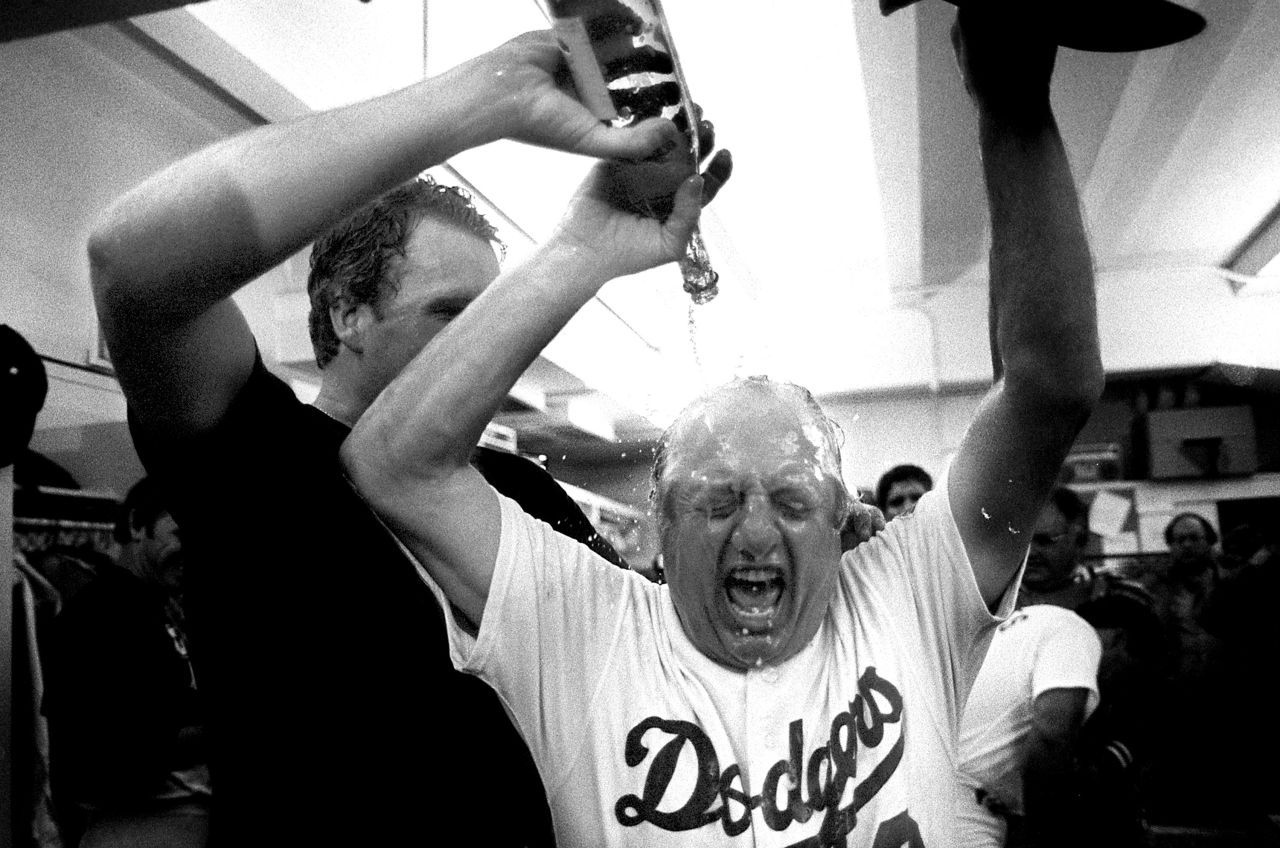 Dodgers pitcher Tom Niedenfuer pours champagne on Lasorda after the team won the 1981 National League Division Series playoffs. The team went on to win the World Series that year.