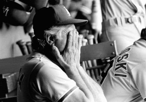 Lasorda covers his face as the San Diego Padres score six runs in the eighth inning to defeat the Dodgers during a game in September 1983.