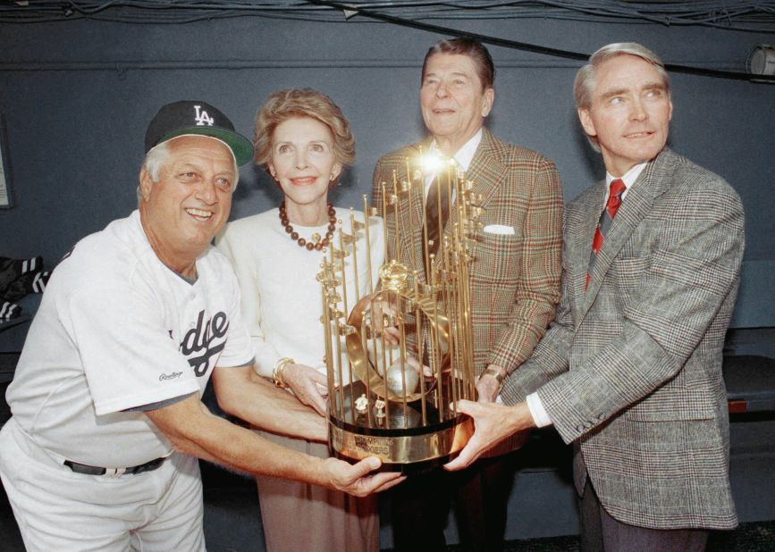 Lasorda, left, and Dodgers executive vice president Fred Claire, right, pose with one of the Dodgers' World Series trophies alongside former President Ronald Reagan and former first lady Nancy Reagan before a home opener in April 1989.