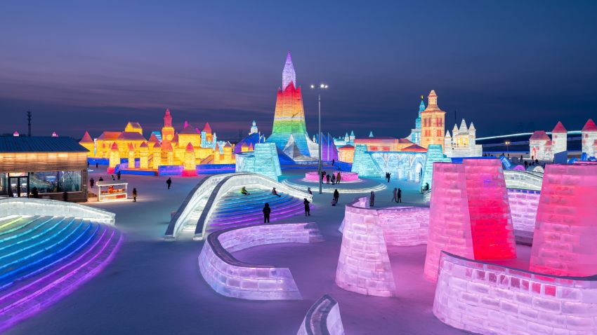 People look at ice sculptures at the Harbin Ice and Snow Festival in Harbin, in northeastern China's Heilongjiang province on January 5, 2021. (Photo by STR / AFP) / China OUT (Photo by STR/AFP via Getty Images)