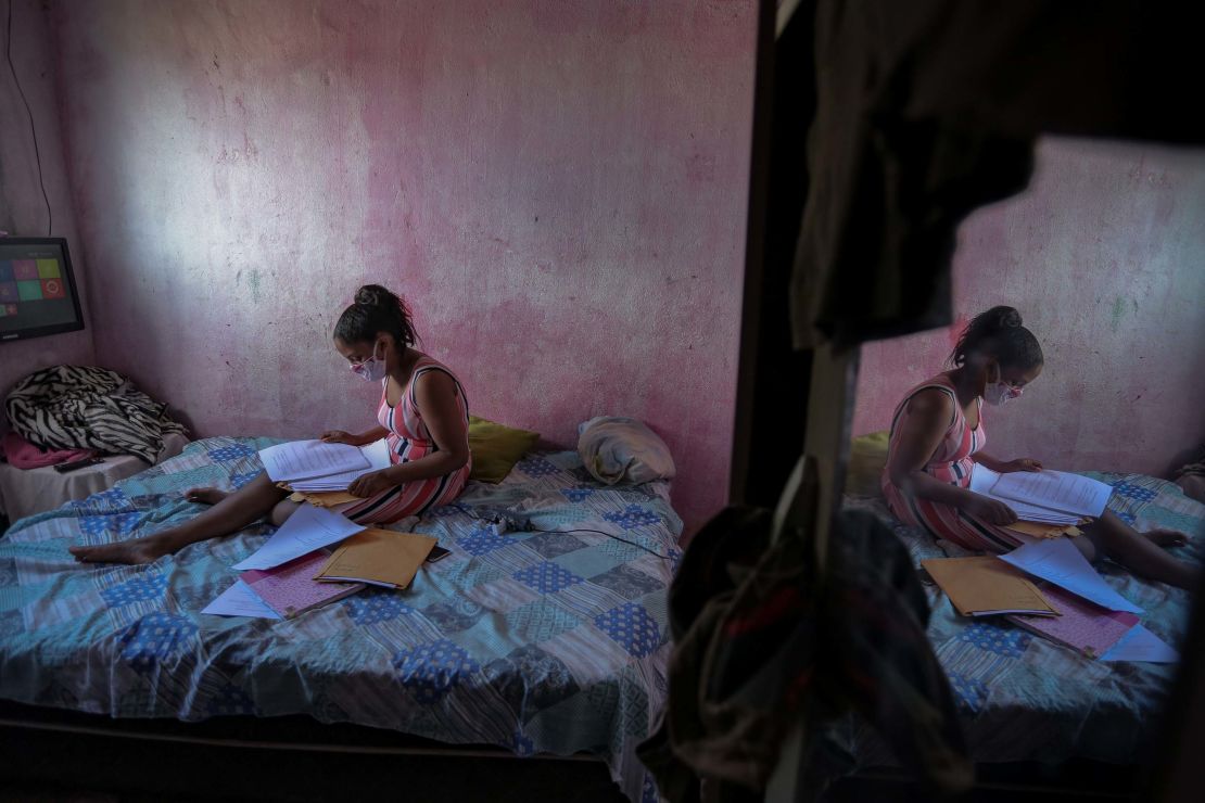 Student Gloria Dayane prepares to do her homework on a printout version of a textbook in Camaragibe, Pernambuco state, Brazil, on July 25, 2020.