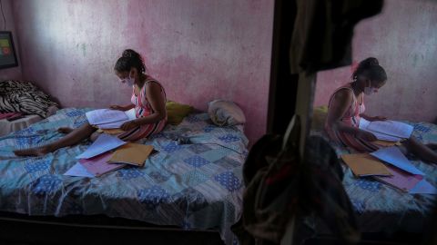 Student Gloria Dayane prepares to do her homework on a printout version of a textbook in Camaragibe, Pernambuco state, Brazil, on July 25, 2020.