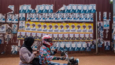 Posters of incumbent President Yoweri Museveni (yellow) and Bobi Wine are seen along a street in Kampala on January 6
