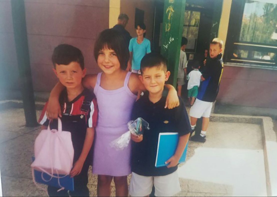 Arnesa Buljusmic-Kustura, center, is pictured with her younger brother and a neighbor on her first day of school after the war ended.