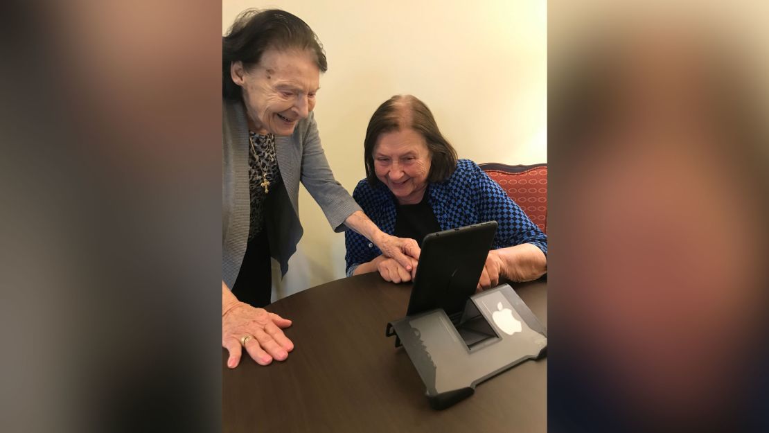 Seniors videochatting with loved ones using a tablet donated by Brighten A Day.