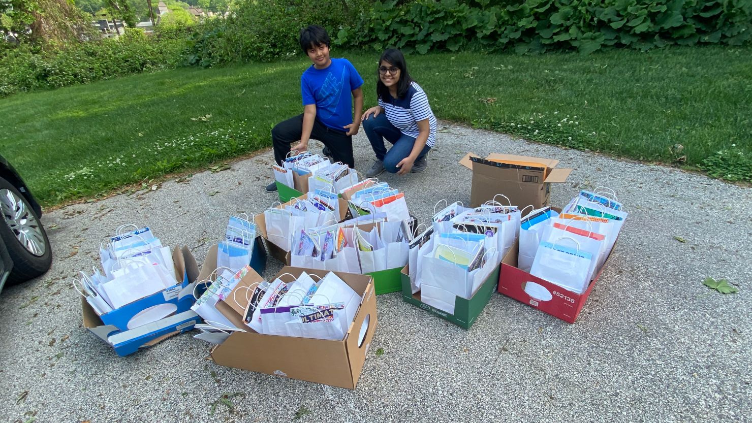 Hita Gupta and her brother, Divit, display care packages they made for seniors.