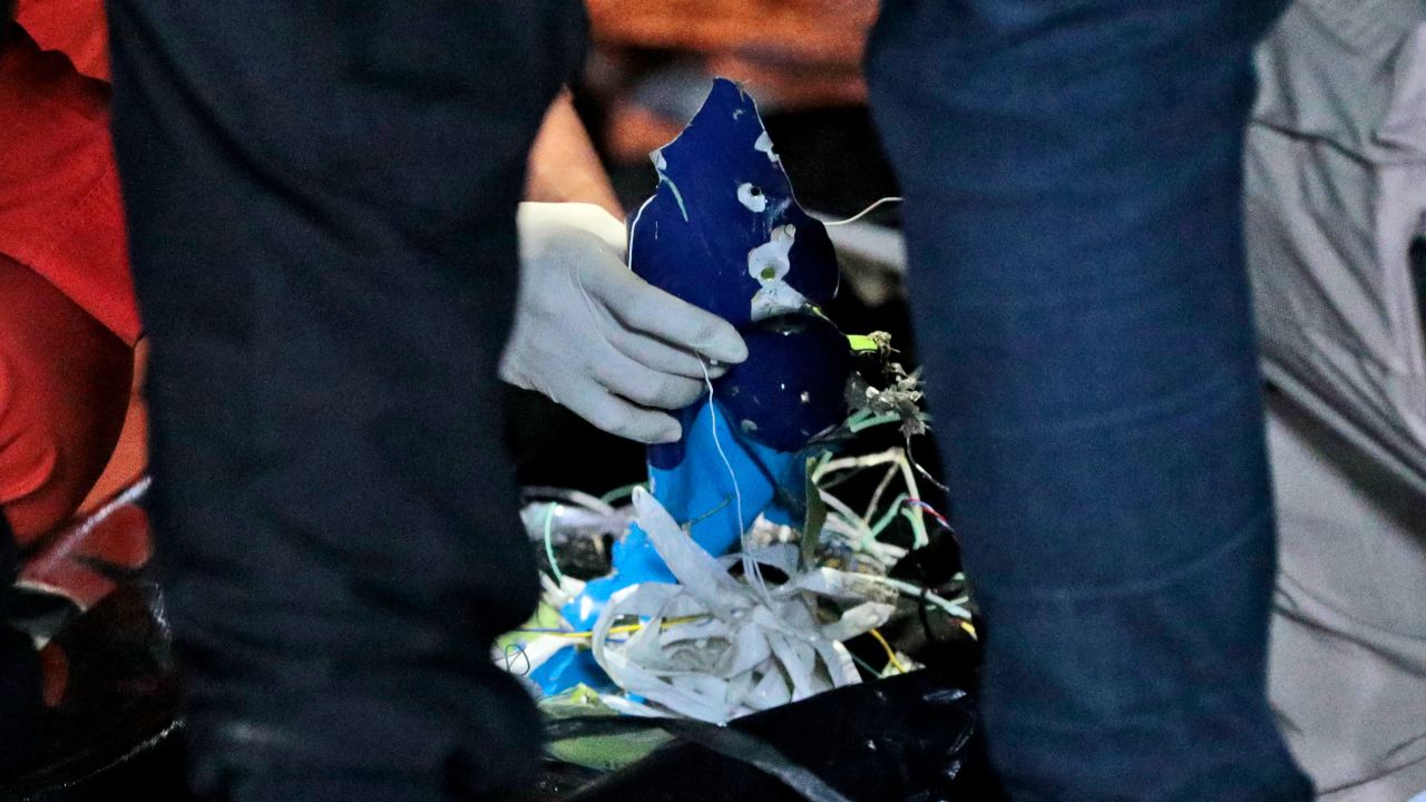 Rescuers examine debris found in the water off Java Island where a Sriwijaya Air passenger jet lost contact, at Tanjung Priok Port in Jakarta on January 10, 2021.