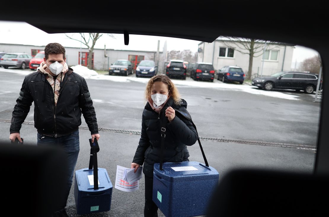 Employees carry boxes with the Pfizer/BioNTech vaccine to a  Covid-19 center near Magdeburg, Germany on January 8.