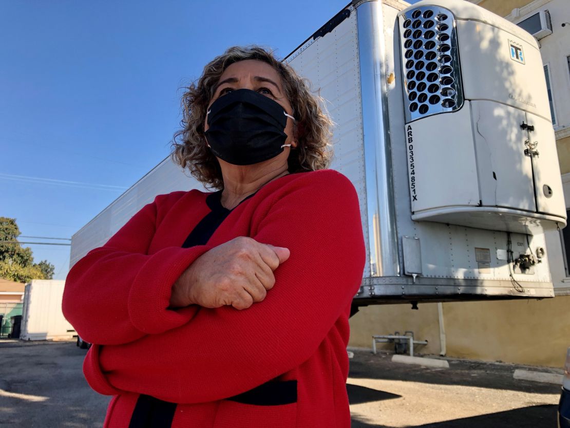 Magda Maldonado stands in front of a freezer trailer Friday outside her mortuary in Montebello, California.