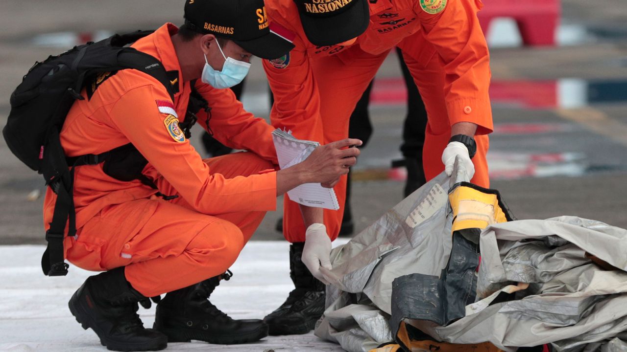 Rescuers inspects debris found in the waters around the location where a Sriwijaya Air passenger jet has lost contact, at the search and rescue command center at Tanjung Priok Port in Jakarta, on January 10, 2021. 