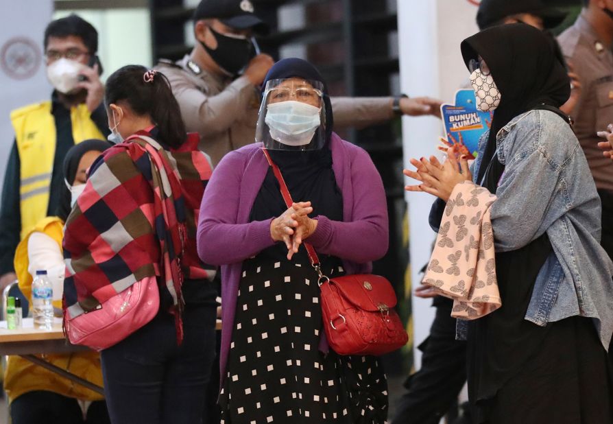 Relatives of passengers arrive at an airport crisis center on Saturday, January 9.