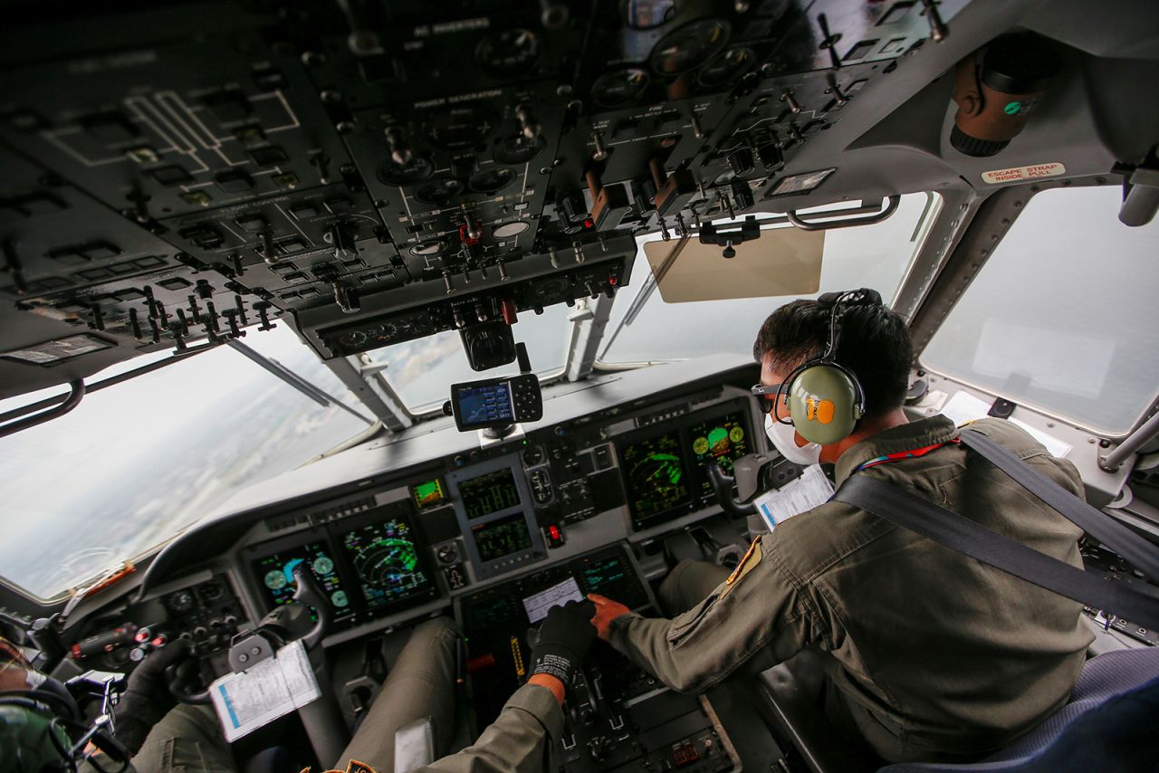 Indonesian Air Force pilots work in the cockpit during an aerial search on January 10.