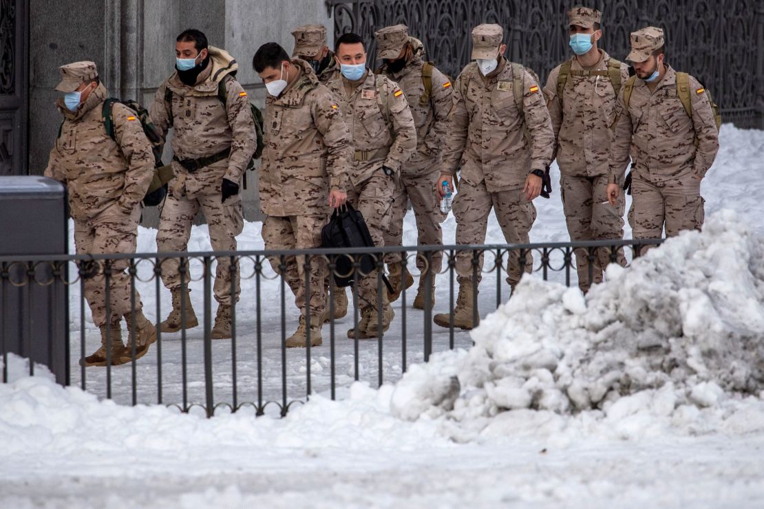 Members of the military walk through snow in downtown Madrid, Spain, Sunday, January 10.