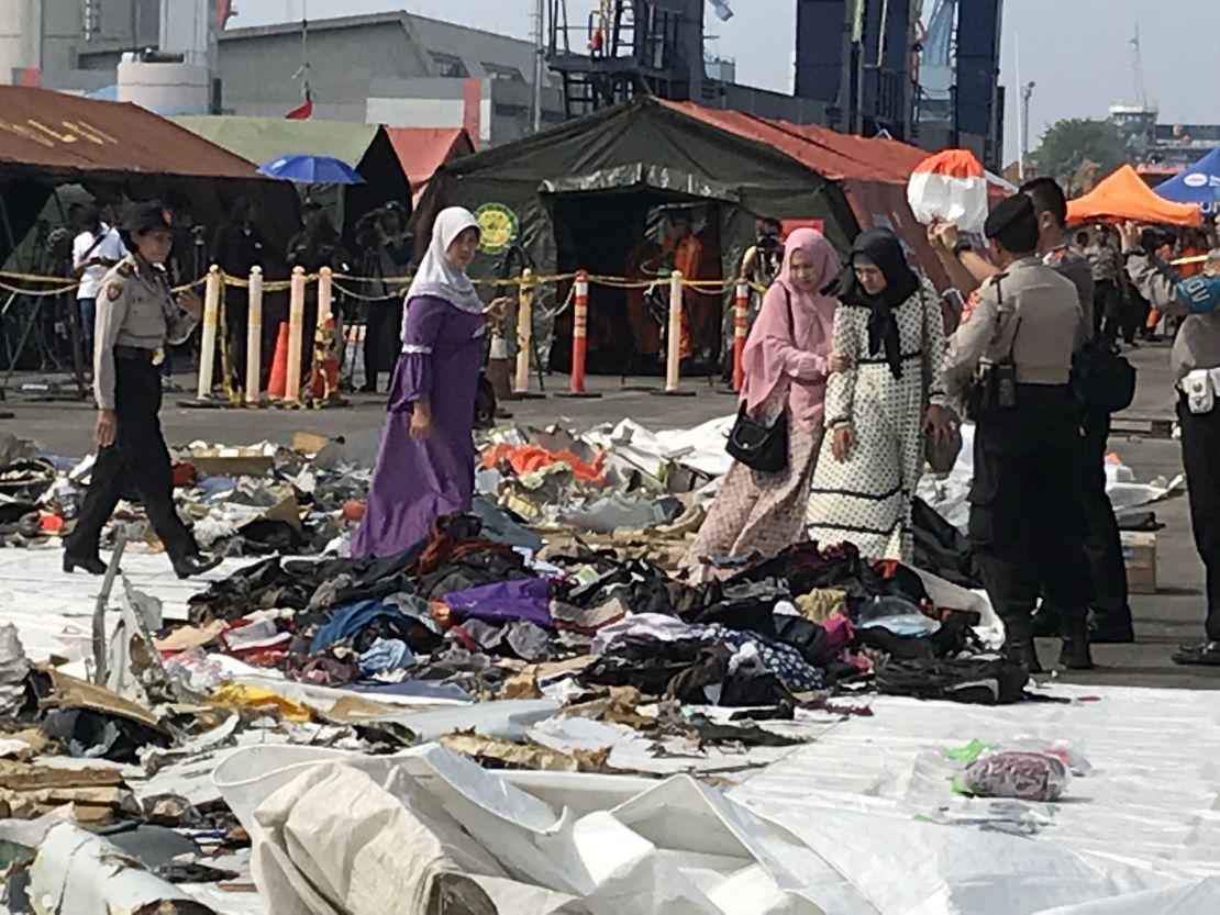 Children's shoes, lined up on a white tarp in the port, as relatives search for items belonging to their loved ones after the October 29, 2018 Lion Air Flight 610 crash.  