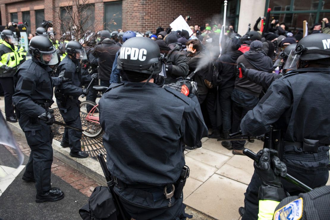 Police officers pepper spray protesters before the inauguration of President-elect Donald Trump in 2017. 