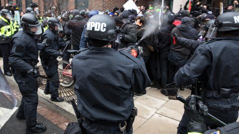 Police officers pepper spray protesters before the inauguration of President-elect Donald Trump in 2017. 