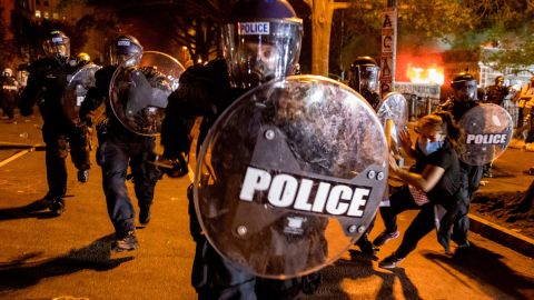 A police officer charges forward during Black Lives Matter protests in front of the White House.
